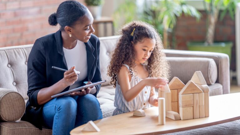 Therapist notes progress of child as she plays