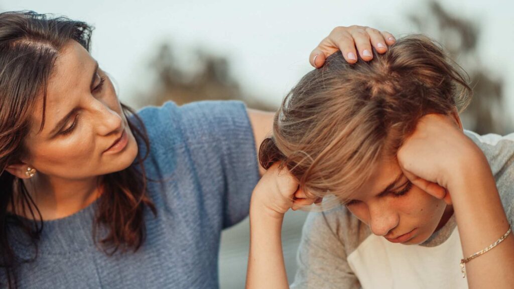 Mother comforting her son